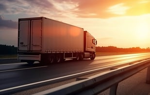 A-semi-trailer-truck-driving-on-a-highway-with-the-sun-setting-in-the-background-3