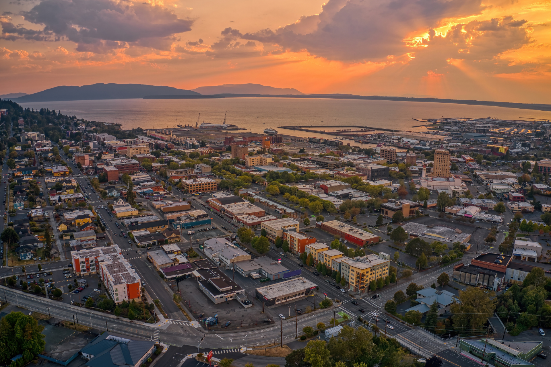 Downtown Bellingham, Washington, with waterfront views of Bellingham Bay and surrounding mountains.